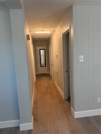 a view of a room with wooden floor and staircase