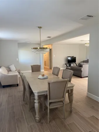 a view of a dining room with furniture and wooden floor