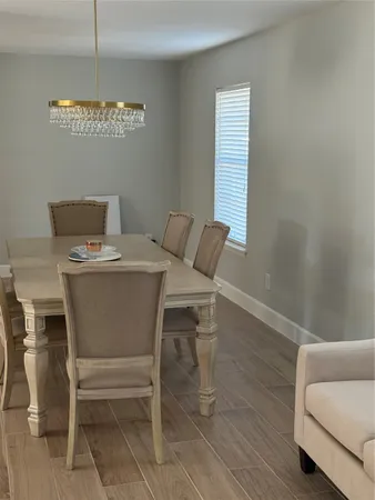 a dining room with furniture and window