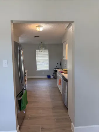 a view of a hallway view with wooden floor and staircase