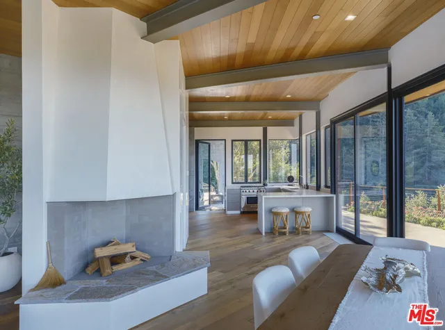 a living room with furniture and large windows