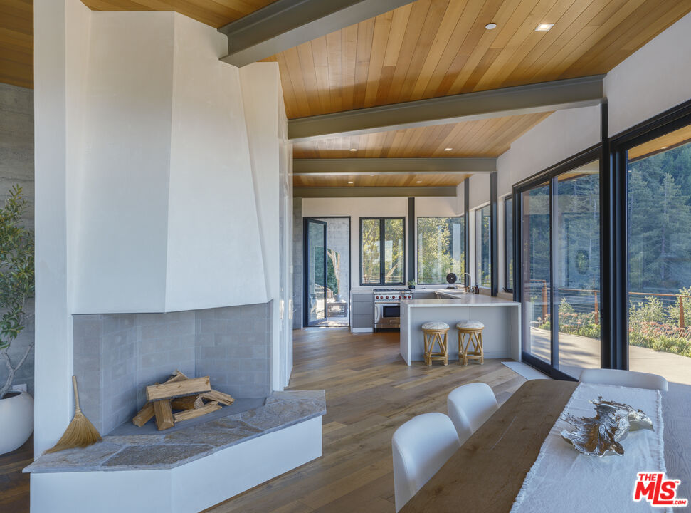 47730 Coast Ridge Road Big Sur, CA 93920 - Photo 11 of 37 a living room with furniture and large windows