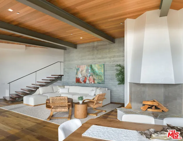 a living room with lots of furniture and a rug