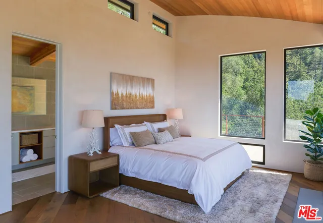 a bedroom with a bed and a fireplace