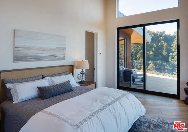 a bedroom with a large bed and a large window