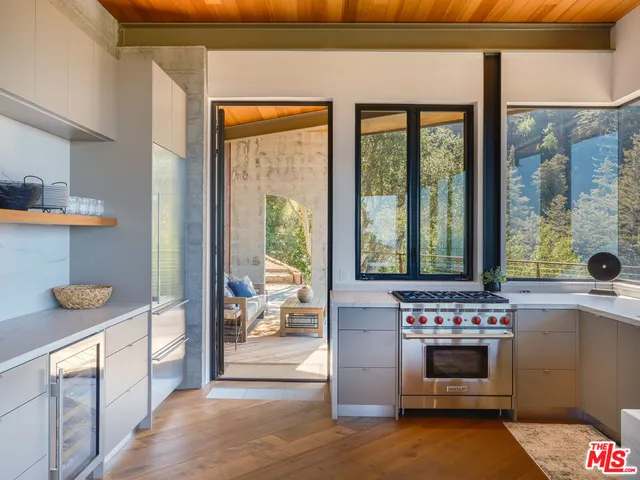 a kitchen with stainless steel appliances a stove and more cabinets