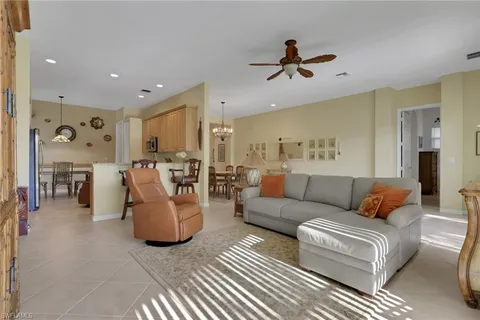a living room with furniture and kitchen view