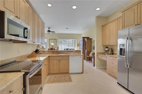 a kitchen with a sink stainless steel appliances and cabinets