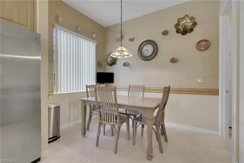 view of a dining room with furniture and wall clock