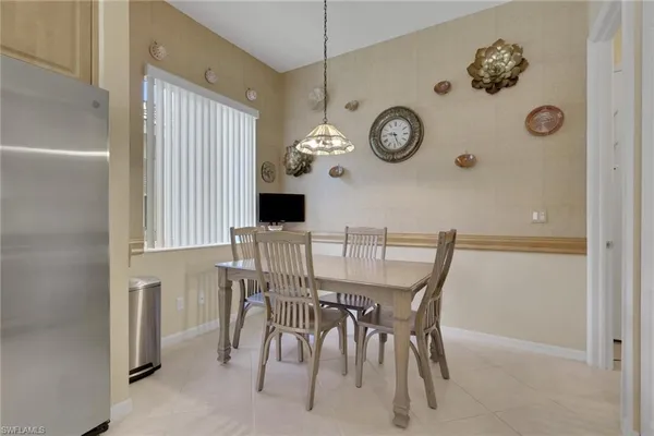 view of a dining room with furniture and wall clock