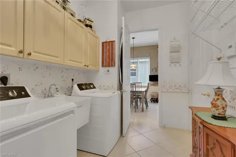 a kitchen with a sink a stove and cabinets