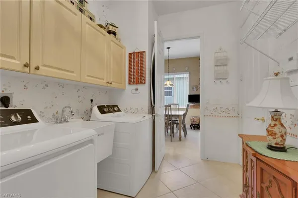 a kitchen with a sink a stove and cabinets