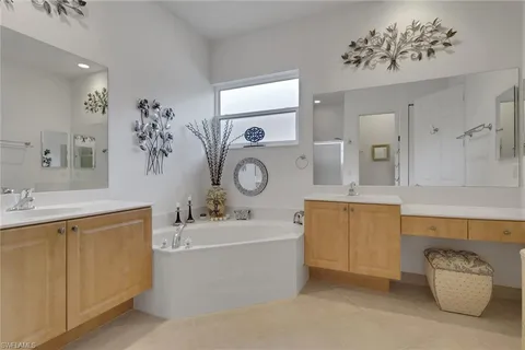 a bathroom with a tub sink and mirror