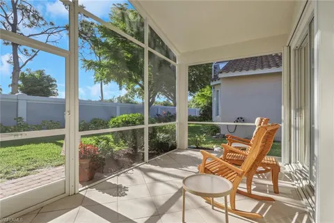 a patio with yard glass top table and chairs