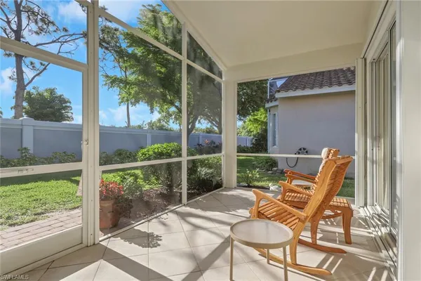 a patio with yard glass top table and chairs