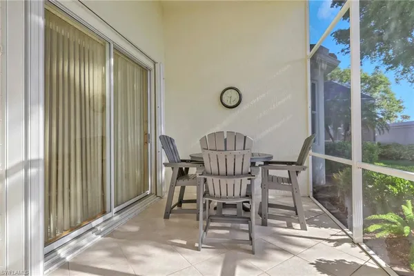 a view of a room with a dining table and chairs