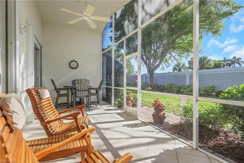 a view of a patio with a table chairs and a backyard
