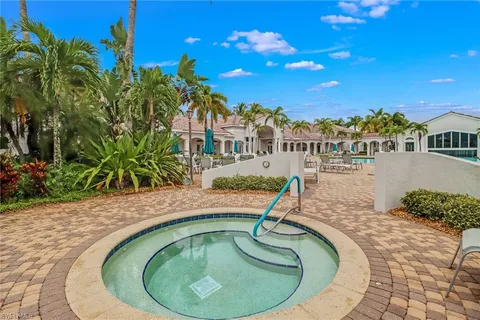 a swimming pool with outdoor seating and yard