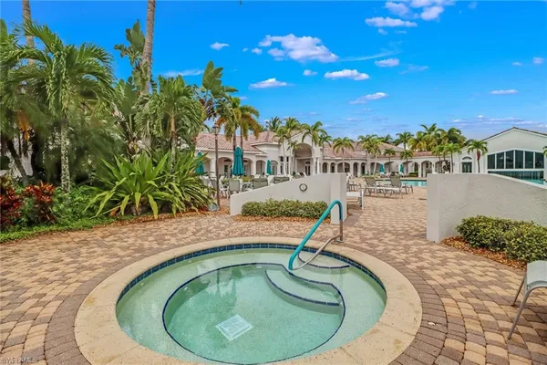 a swimming pool with outdoor seating and yard