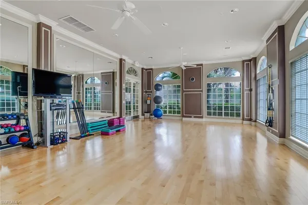 a view of a livingroom with wooden floor and furniture