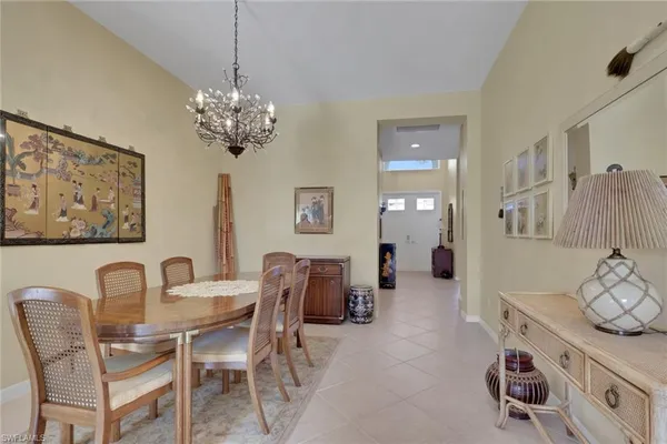 a view of a dining room with furniture and a chandelier