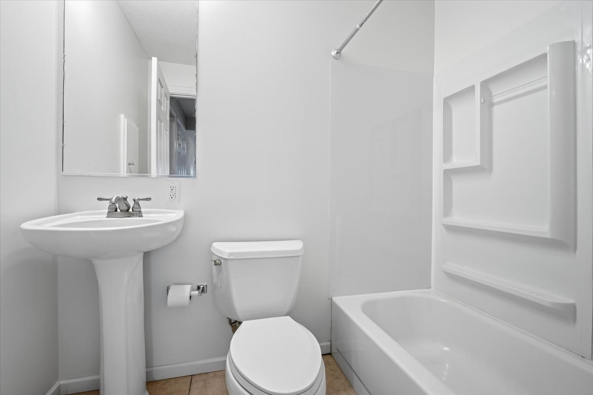 915 Teegan Street Normal, IL 61761 - Photo 21 of 33 a white toilet sitting next to a bathroom sink