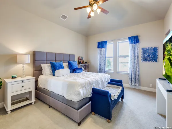 a bed room with a bed and a chandelier