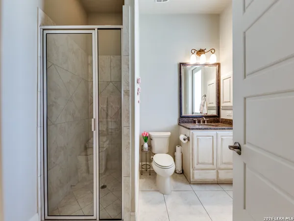 a bathroom with a toilet a sink and a shower