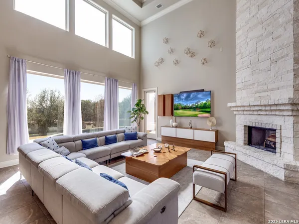 a living room with furniture a fireplace and a flat screen tv