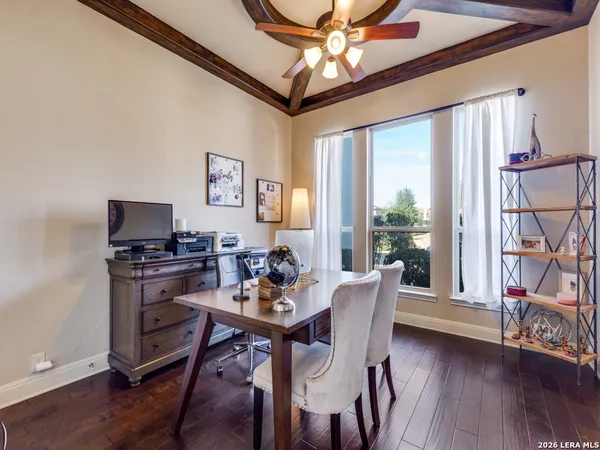 a dining room with furniture window and wooden floor