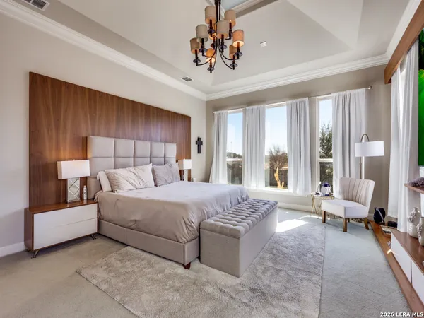 a bed room with a bed and large windows