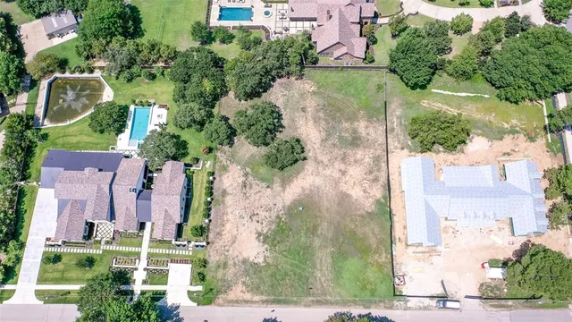 an aerial view of a house with a yard and potted plants