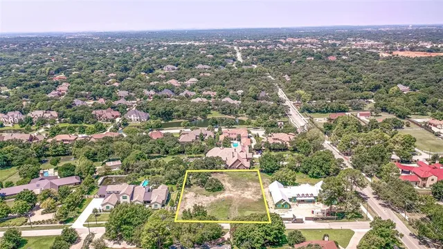 an aerial view of residential houses with outdoor space and trees
