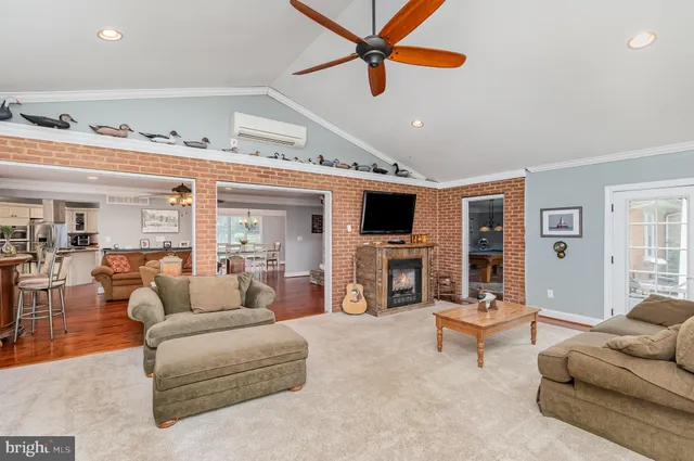 a room with pool table flat screen tv and windows
