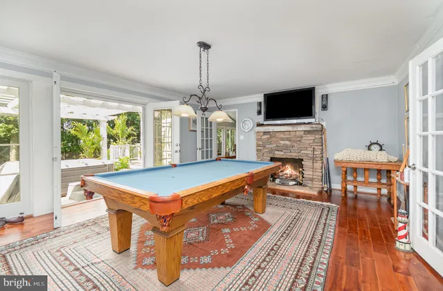 a kitchen with stainless steel appliances granite countertop a stove a refrigerator a oven a sink with a dining table and chairs