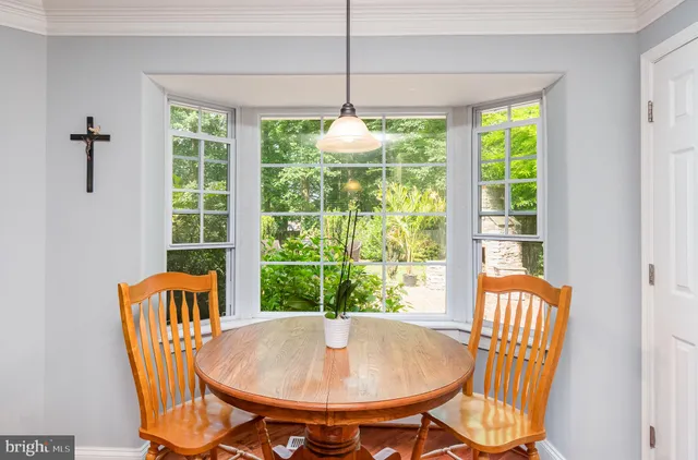 a kitchen with stainless steel appliances granite countertop a stove top oven a sink dishwasher and a refrigerator with wooden floor