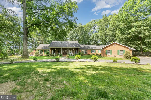 a front view of a house with a big yard