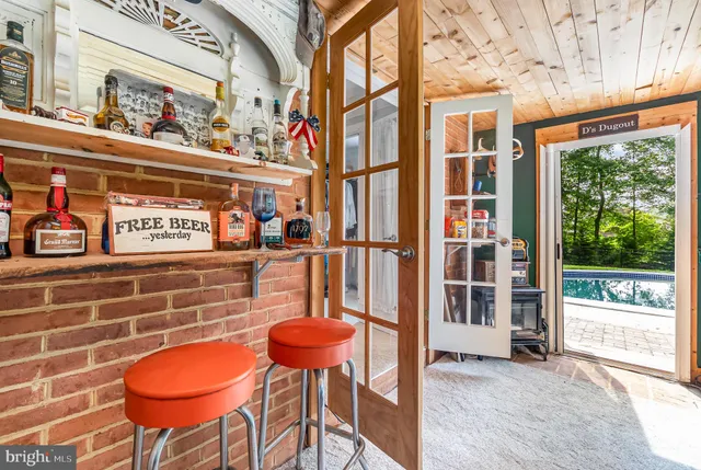 a view of a backyard with table and chairs with wooden floor and fence