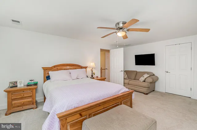 a view of a swimming pool with a yard and large trees