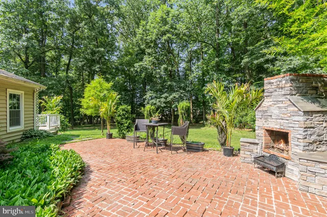 an aerial view of a house with a yard and trees