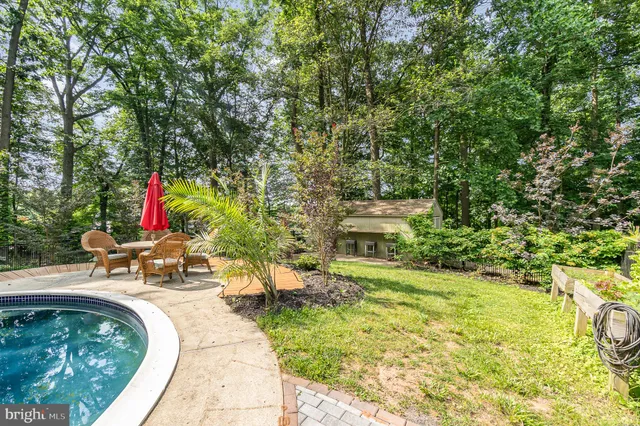 a front view of a house with yard and green space