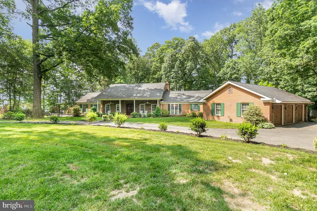 a front view of a house with a yard table and chairs