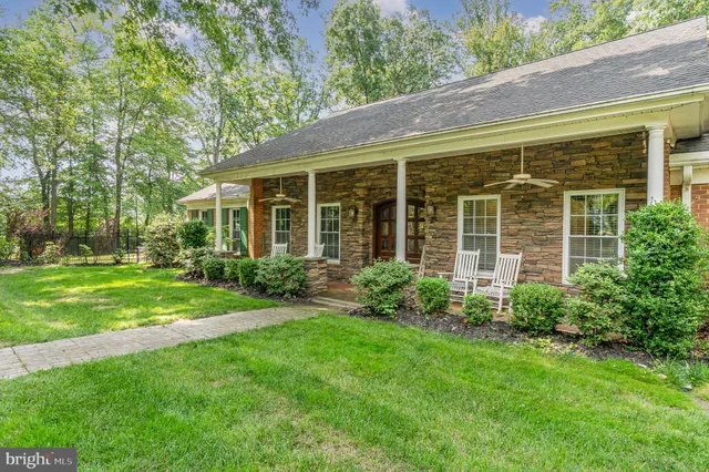 a living room with a rug floor to ceiling windows and a rug
