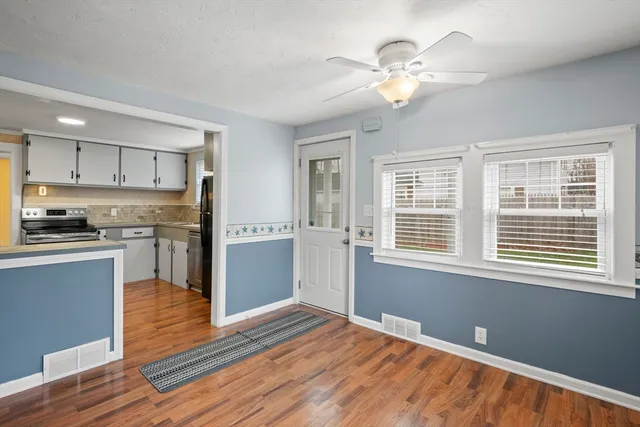 a kitchen with a refrigerator and a stove top oven