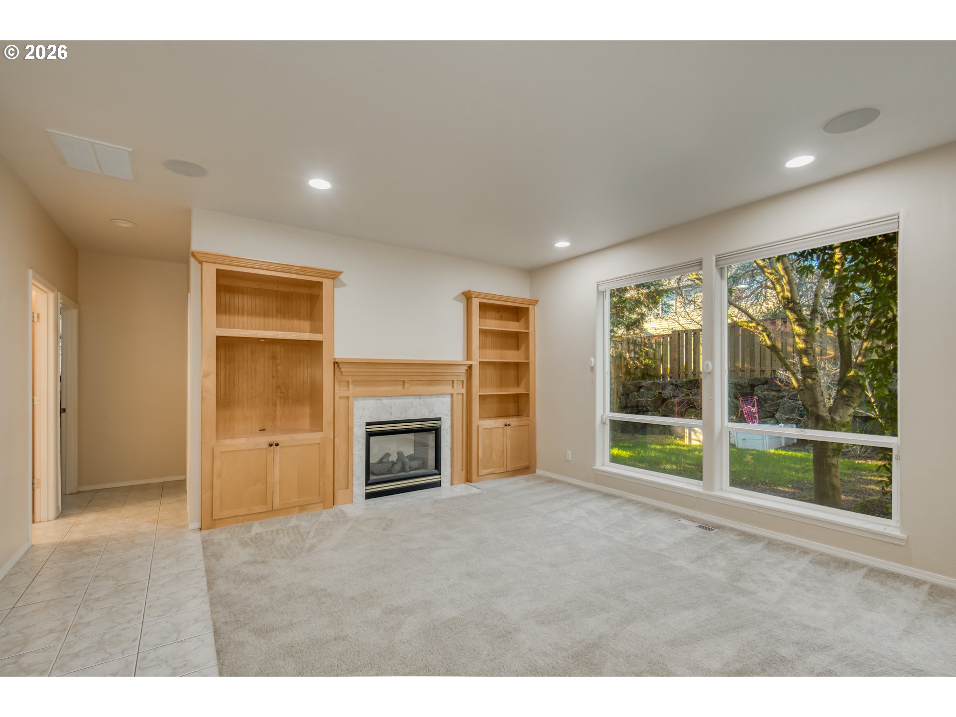 3637 Northwest Lansbrook Terrace Portland, OR 97229 - Photo 13 of 43 a view of an empty room with a fireplace and a window