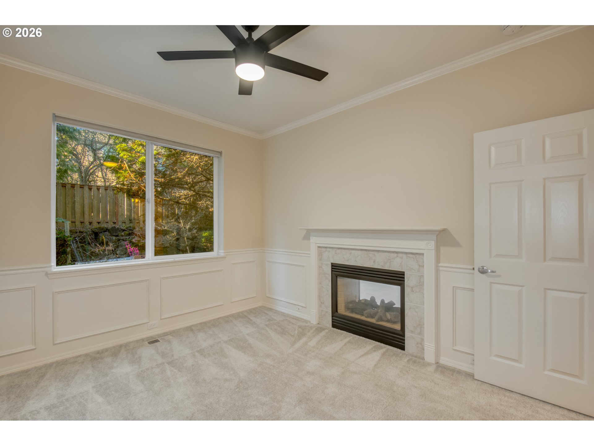 3637 Northwest Lansbrook Terrace Portland, OR 97229 - Photo 16 of 43 a view of an empty room with a fireplace and a window