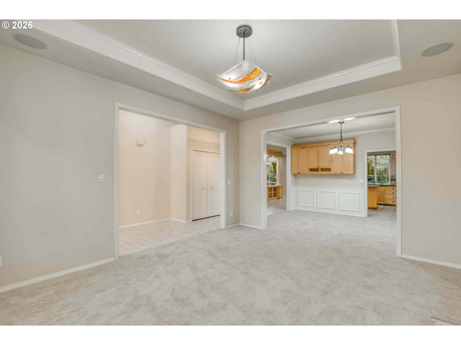 3637 Northwest Lansbrook Terrace Portland, OR 97229 - Photo 5 of 43 a view of an empty room and kitchen with a ceiling fan