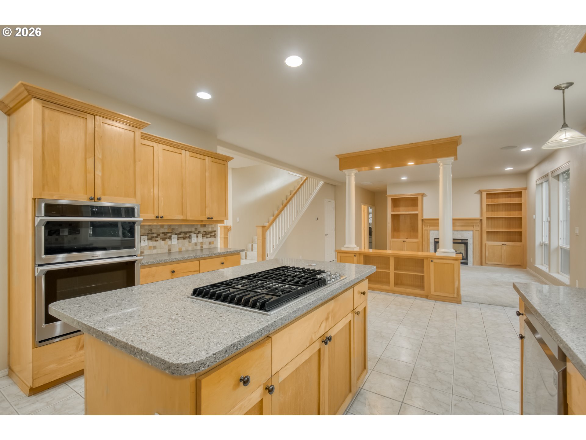 3637 Northwest Lansbrook Terrace Portland, OR 97229 - Photo 9 of 43 a kitchen with stainless steel appliances kitchen island a stove a sink and a microwave
