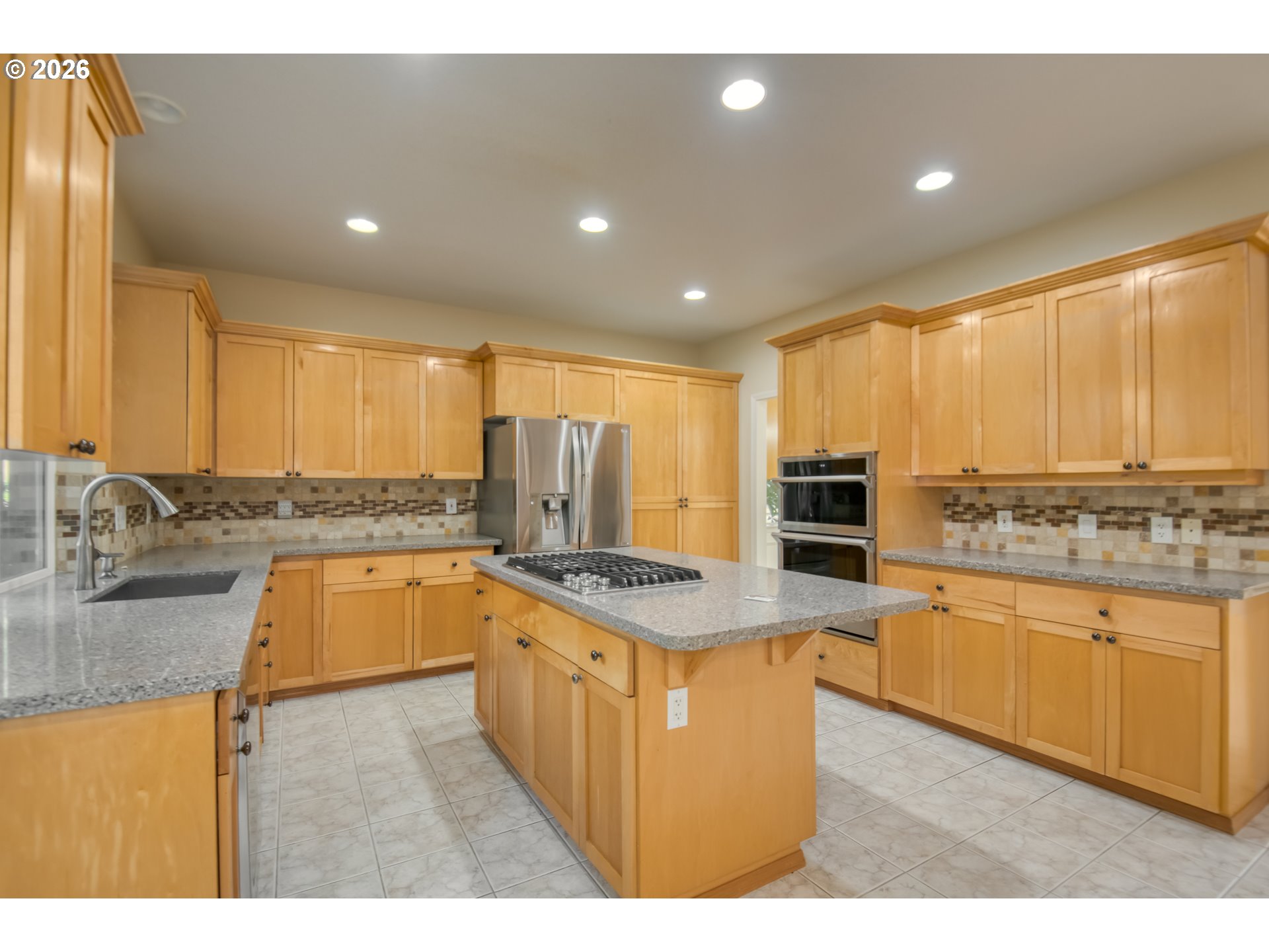 3637 Northwest Lansbrook Terrace Portland, OR 97229 - Photo 10 of 43 a kitchen with stainless steel appliances granite countertop a stove a sink and a refrigerator