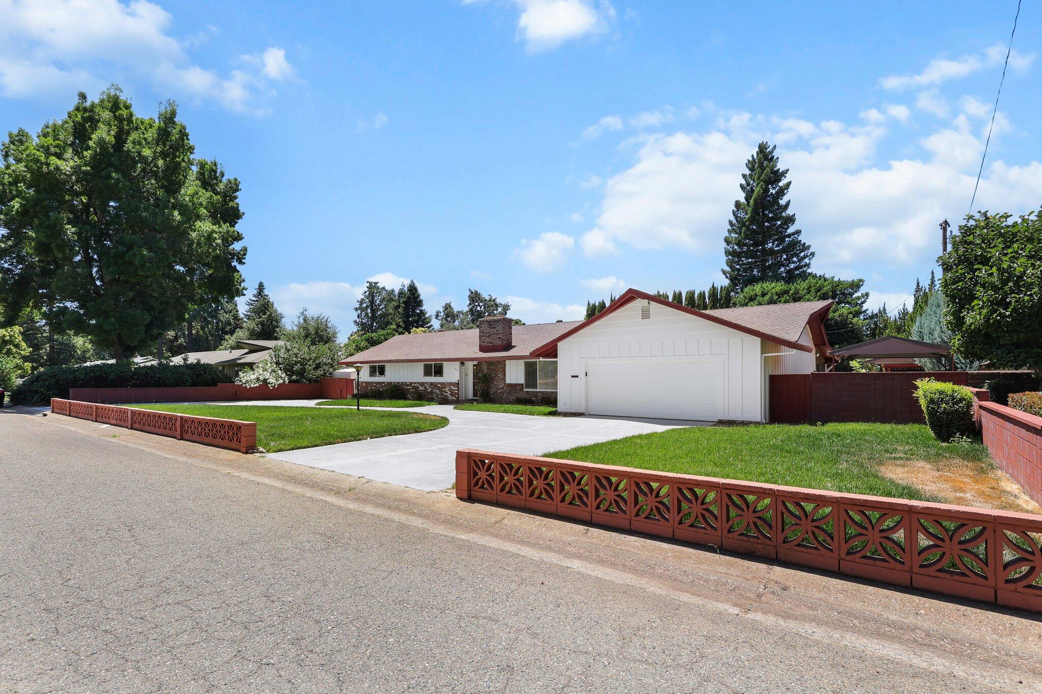 910 Hallmark Drive Redding, CA 96001 - Photo 35 of 40 a view of an house with backyard and bushes
